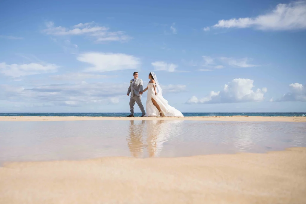 Couple walking hand in hand along the beach