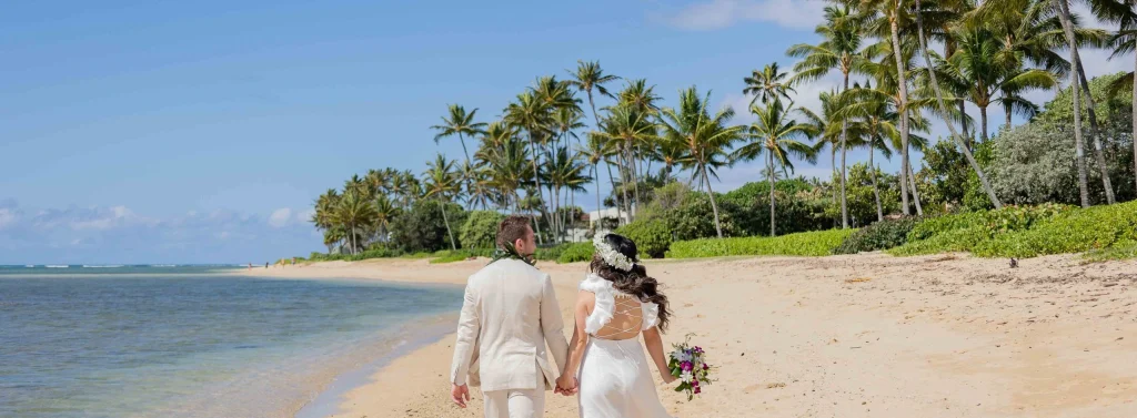 Bride and Groom Walking on Waialae Beach, Hawaii