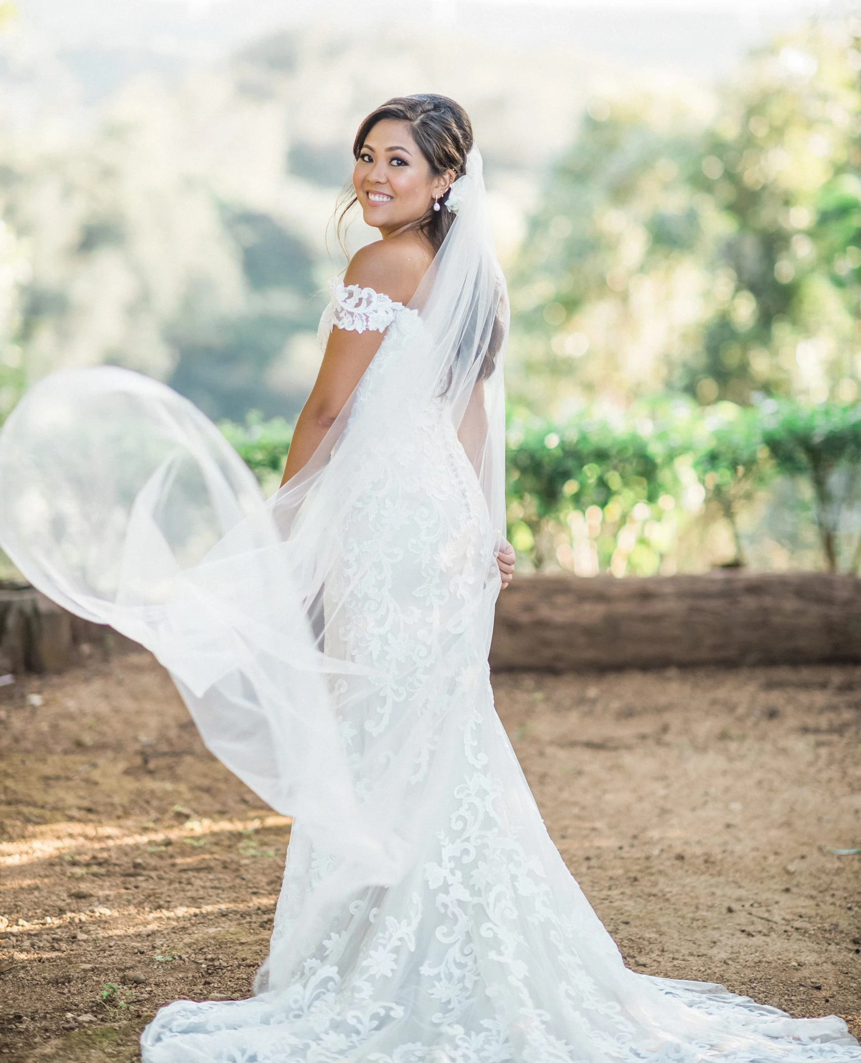 Bride in lace wedding dress outdoors