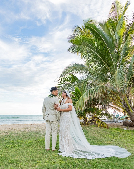 Beach wedding couple under palm trees