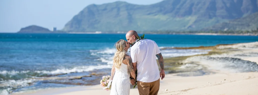 Beach wedding couple with ocean view and sunset
