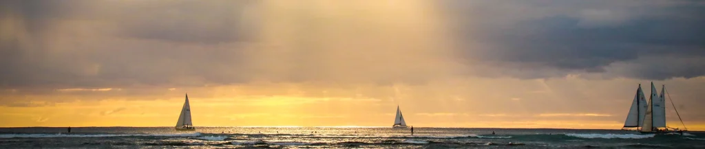 Waikiki Beach with sailboats and sunset sky