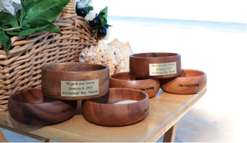 Engraved wooden wedding rings on beach